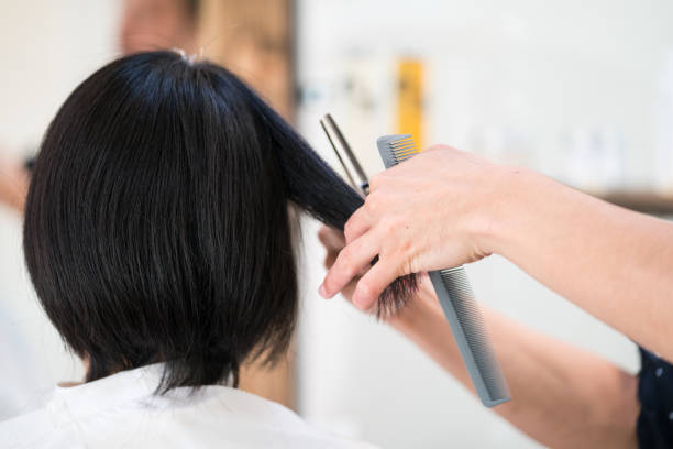A woman getting her hair cut